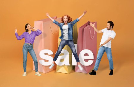 Photo for Shopping Sales Offer. Three Excited Customers Posing With Word Sale And Large Shopper Bags, Having Fun Jumping And Gesturing Advertising Black Friday Discounts On Orange Background. Collage - Royalty Free Image