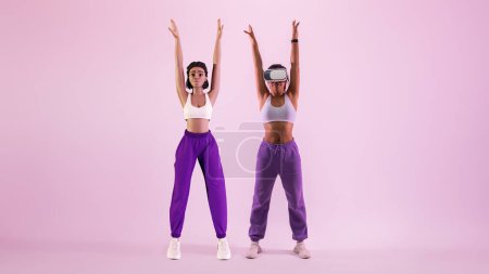 Foto de Sesión de entrenamiento metaverso. Deportiva joven mujer negra en gafas vr explorar juego de fitness realidad virtual como avatar 3D, estirando su cuerpo, fondo de estudio púrpura - Imagen libre de derechos