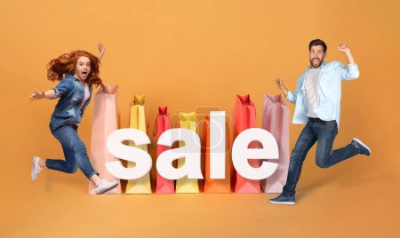 Photo for Shopping Joy. Excited Shopaholics Couple Jumping Near Huge Paper Shopper Bags And Word Sale, Advertising Discounts And Gesturing Yes Over Orange Studio Background. Collage, Full Length - Royalty Free Image