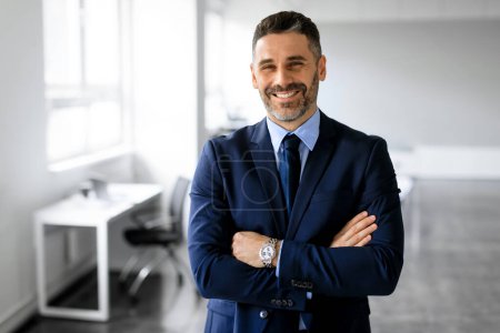 Photo for Successful european middle aged businessman standing crossing hands posing with confidence in office and smiling at camera. Career success, growth and achievement concept - Royalty Free Image