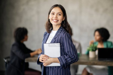Photo for Successful Business Career. Happy Brunette Businesswoman Holding Digital Tablet Posing At Modern Office, Smiling At Camera, During Corporate Meeting. Entrepreneurship And Leadership - Royalty Free Image