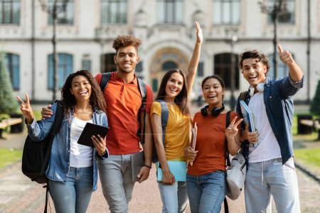 Photo for Freshmen Orientation Concept. Group Of First Year Students With Workbooks Posing Together Outdoors, Happy Multiethnic Young People Standing Near University Building And Smiling At Camera - Royalty Free Image