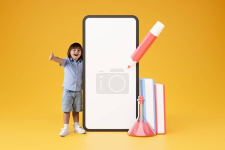 Photo for E-Learning Application. Preschool Boy Gesturing Thumbs Up Near Big Cellphone With Blank Touchscreen, Approving Mobile App And Educational Gadgets With Like Standing On Yellow Background, Collage - Royalty Free Image