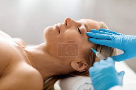 Photo for Mesotherapy Concept. Cosmetologist doctor doing facial rejuvenation injection to middle aged woman, beautiful mature female getting aesthetic cosmetology treatment in beauty salon, closeup shot - Royalty Free Image