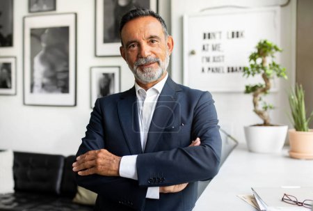 Photo for Smiling confident handsome caucasian senior bearded businessman in suit with crossed arms on chest in modern office interior. Work, eco business, boss and ceo manager, leader - Royalty Free Image