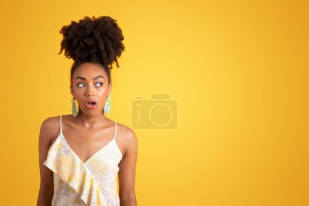 Photo for Positive surprised millennial black woman student in dress with open mouth look at empty space, isolated on orange background, studio. Huge sale, ad and offer, fashion and lifestyle, human emotions - Royalty Free Image