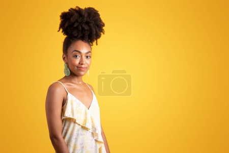 Photo for Positive pretty millennial black curly lady in dress enjoy weekend, isolated on orange background, studio. Sale, ad and offer, fashion and lifestyle, summer party, trip at holiday - Royalty Free Image