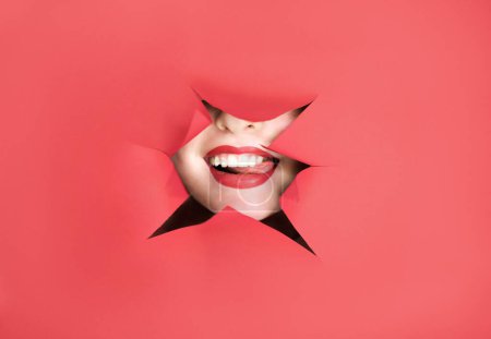 Photo for Makeup Concept. Woman Playing With Tongue Through Hole In Torn Red Paper, Unrecognizable Female With Beautiful Smile Demonstrating Lips After Permanent Make Up Procedure, Creative Collage - Royalty Free Image