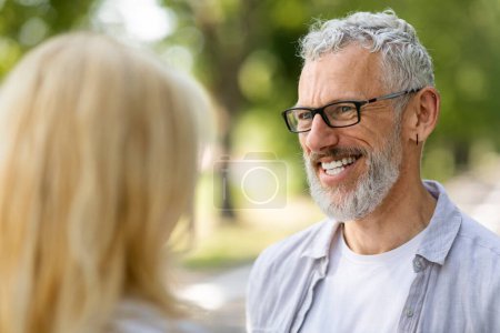 Photo for Handsome Mature Man Looking At His Wife With Love And Smiling While They Standing Outside, Happy Senior Couple Bonding Together, Chatting And Having Fun, Enjoying Romantic Outdoor Date, Closeup - Royalty Free Image