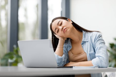 Photo for Educational exhaustion and overwork. Exhausted asian student lady sleeping in front of laptop tired of online learning and classes, sitting at table indoors - Royalty Free Image