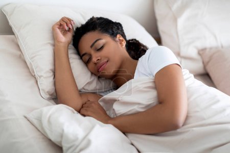 Photo for Portrait Of Young Beautiful Black Woman Sleeping In Comfortable Bed At Home, Closeup Shot Of Calm Millennial African American Lady Napping In Cozy Bedroom, Lying On Soft Pillow And Smiling - Royalty Free Image