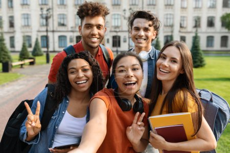 Photo for Happy Multiethnic Group Of Students Making Selfie Outdoors Together, Diverse Cheerful College Friends Looking And Smiling At Camera, Posing Near University Building, Enjoying Studentship, Closeup - Royalty Free Image