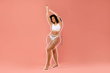 Photo for Hot young black woman posing in white underwear, raising hands up, showing beautiful curves of her body, standing on pink studio background, showing weigh loss results, copy space, full length - Royalty Free Image