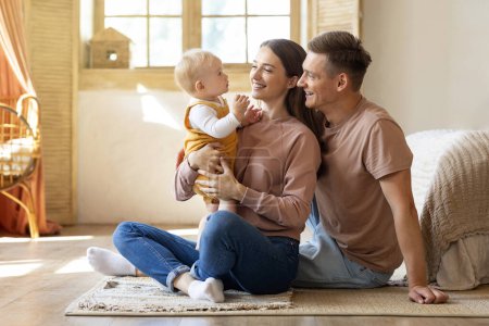 Photo for Portrait Of Happy Young Parents Having Fun With Their Infant Son At Home, Loving Caucasian Family Of Three With Adorable Toddler Baby Embracing And Smiling, Enjoying Time Together, Copy Space - Royalty Free Image