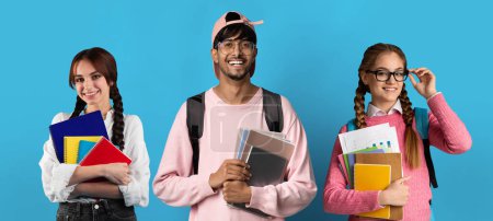Photo for Group Of Cheerful Young Multiethnic Students With Backpacks And Workbooks Posing Over Blue Studio Background, Diverse Happy College Friends Standing On Colorful Backdrop, Smiling At Camera, Collage - Royalty Free Image