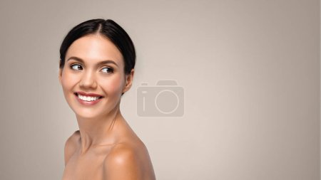Photo for Glad pretty young caucasian lady look at back, enjoy beauty care, isolated on gray studio background, panorama. Spa procedures, lifestyle, vitality and lifting treatment, ad and offer - Royalty Free Image
