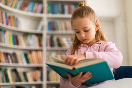 Schoolgirl in classroom, carefully leafing through a book, exploring its content with interest, embodying keen spirit of learning and discovery within an educational and diverse setting
