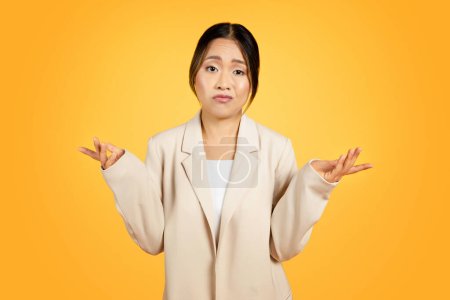 Photo for Bewildered Asian millennial woman stands confronted with difficult choice, facial expressions confused, pensive. Engaged in deep thought, weighs options, encapsulating challenge of decision making - Royalty Free Image