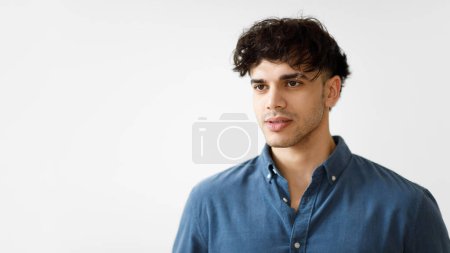 Photo for Shot Of Handsome Arab Guy With Eyebrow Piercing Ring Looking Aside At Blank Space, White Background. Studio Portrait Of Young Middle Eastern Man In Casual. Panorama - Royalty Free Image