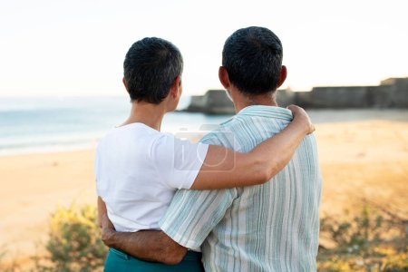 Photo for Senior Couple Embracing Sharing Love And Tenderness Standing At Beautiful Ocean View Outside, Back View Shot. Dream Vacation In Golden Years And Holidays At Oceanside Concept - Royalty Free Image