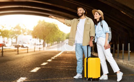 Photo for Happy millennial caucasian couple with suitcase stop, taxi, wait transport on station, full length. Traveling together, active lifestyle, relationships and adventure, panorama - Royalty Free Image