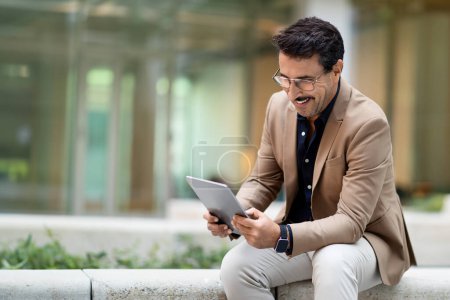 Photo for Busy mature man in formal suit manager using digital tablet outdoors. Middle aged businessman chatting on pad before business meeting, checking email or business mobile app, copy space - Royalty Free Image
