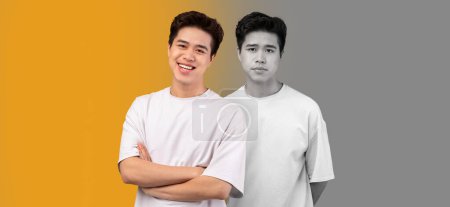 Photo for Smiling, despaired and unhappy millennial asian guy suffer from depression on yellow and gray background, studio, panorama. Mental problems, stress human emotions, bad mood - Royalty Free Image