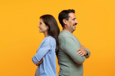Photo for Happy confident senior caucasian family in casual, back to back with crossed arms on chest, isolated on orange studio background. Family lifestyle, relationships and team - Royalty Free Image