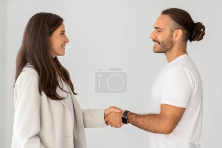Photo for Successful Deal Concept. Portrait Of Millennial Man Buying New Apartment, Shaking Hands With Professional Real Estate Agent. Smiling Manager In Suit Selling Flat To Happy Young Guy - Royalty Free Image