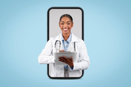 Photo for Happy millennial black woman doctor write at clipboard on big smartphone screen, isolated on blue background, studio, collage. Medical consultation app remotely and blog website - Royalty Free Image