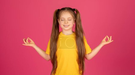 Photo for Zen. Relaxed Little Girl Meditating With Closed Eyes Over Pink Background, Calm Cute Female Child Practicing Yoga, Keeping Hands In Mudra Gesture While Posing In Studio, Copy Space - Royalty Free Image