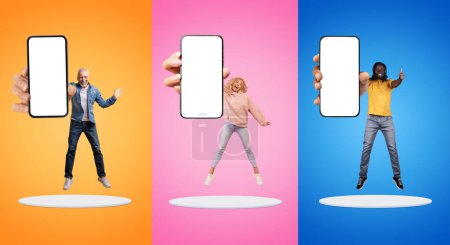 Photo for Smiling excited millennial, old european and black people show smartphone with empty screen, jump at platform, enjoy win, isolated on multicolored background. Thumb up gesture, approve app - Royalty Free Image