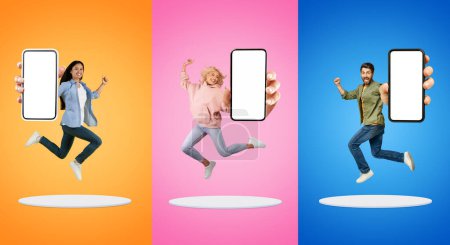 Photo for Cheerful young asian and european people with open mouth, scream, show big phone with empty screen, jump at platform, have fun, isolated on multicolored background. App recommendation, chat - Royalty Free Image