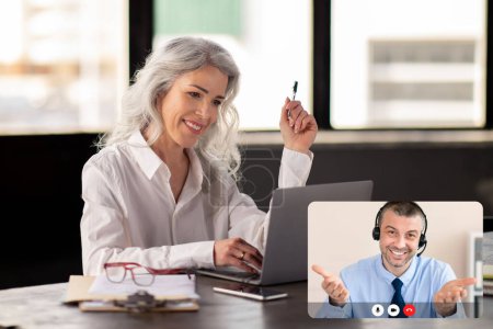 Photo for Mature grey-haired woman entrepreneur have video chat with business consultant, sitting at office, using laptop, attending online meeting with business partner. Telecommunication concept - Royalty Free Image