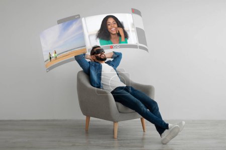 Téléchargez les photos : Young arabic guy experiencing augmented reality in headset sitting at home, communicating with his black wife appearing on futuristic digital screen. Collage of diverse couple having VR video call - en image libre de droit