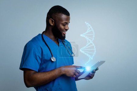 Photo for Progress of diagnostics healthcare. Professional young black man doctor studying virtual DNA strand on digital tablet, blue studio background - Royalty Free Image
