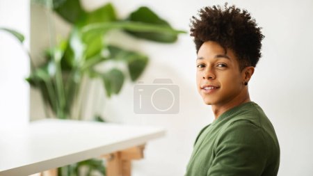 Photo for Portrait of handsome young black guy enjoying time at cafe, smiling at camera, waiting for friend or for a date. Millennials lifestyle, leisure concept, panorama with copy space - Royalty Free Image