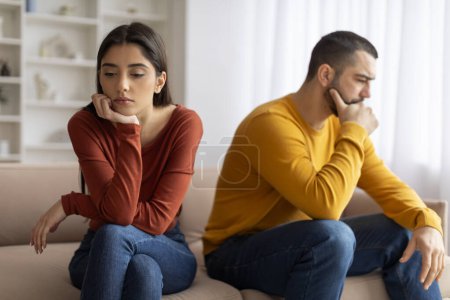 Photo for Upset Young Man And Woman Offended To Each Other After Argue At Home, Pensive Millennial Spouses Sitting On Couch With Thoughtful Face Expression, Suffering Relationship Crisis After Domestic Quarrel - Royalty Free Image