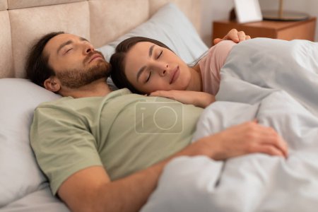 Photo for Relaxed man and woman in deep sleep, cuddling in serene and cozy bedroom, displaying sense of peace and comfort in their slumber - Royalty Free Image