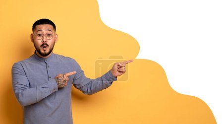 Photo for Wow Offer. Surprised Asian Man Points At Speech Bubble Indicating Copy Space, Showing Blank Mockup Area For Advertisement Text Over Yellow Studio Background, Collage, Panorama - Royalty Free Image