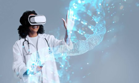Photo for Happy young african american curly woman in white coat and vr glasses touches hologram of 3D model of DNA chain, grey background, studio. Treatment with technology, science, medicine, health care - Royalty Free Image