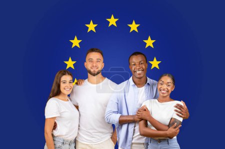 Photo for Two happy couples in casual wear embracing and smiling against a blue backdrop with the European Union flags circle of stars, conveying friendship, studio. Study, education - Royalty Free Image