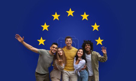 Photo for Five exuberant friends millennial embracing and waving with joy, standing together against a deep blue background emblazoned with the European Unions golden stars, studio, panorama - Royalty Free Image
