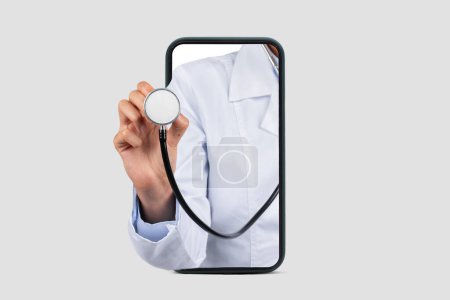 Photo for Caucasian millennial doctor in white coat, listen breathe with stethoscope on big phone screen, cropped, close up, isolated on gray studio background. Medical exam, health care app - Royalty Free Image