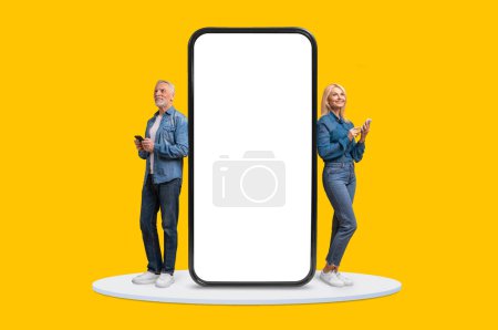 Mature man and woman using smartphones next to an oversized blank screen, representing the intersection of technology and senior lifestyle, yellow background