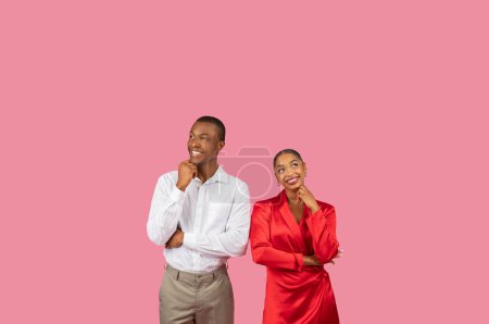 Photo for Contemplative black couple, man and woman with hands on their chins, looking upwards in thought at free space against spacious pink background - Royalty Free Image
