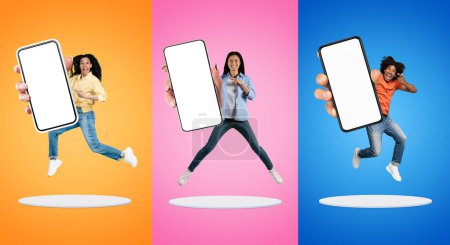 Photo for Three Excited People Jumping With Big Blank Smartphone In Hands On Platforms Against Colorful Backgrounds, Happy Multiethnic Man And Women Pointing At White Screen, Recommending New App, Mockup - Royalty Free Image