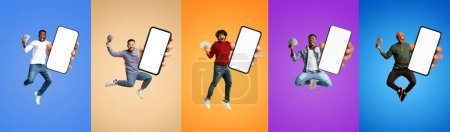Photo for Big Profit. Joyful Multiethnic Men Jumping With Dollar Cash Money And Blank Smartphone In Hands, Happy Young Guys With Empty Cellphone Having Fun Over Colorful Backgrounds, Celebrating Win, Mockup - Royalty Free Image