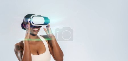 Photo for African American fitness lady wearing VR goggles, engaged in digital workout game in virtual reality, over white studio background, blending technology and health. Panorama, empty space - Royalty Free Image