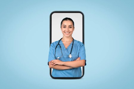 Photo for Professional and friendly female nurse in blue scrubs, with stethoscope around her neck, stands with crossed arms, exuding confidence and competence - Royalty Free Image